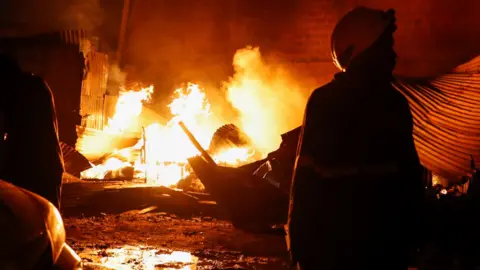 Reuters A firefighter gathers at the scene of an explosion at a makeshift gas cylinder refilling depot in Mradi estate, Embakasi district of Nairobi