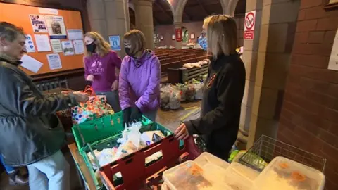 BBC Volunteers hand out items at St Aidan's Kitchen food bank