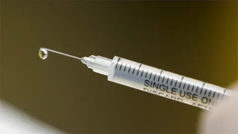 Reuters syringe with vaccine