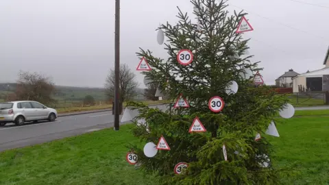 Gwennol Ellis Christmas tree decorated with 30mph signs