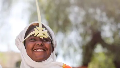 An Ethiopian Orthodox churchgoer wears a palm headdress.