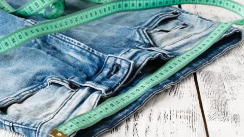 Getty Images A boy stood on a weighing scale