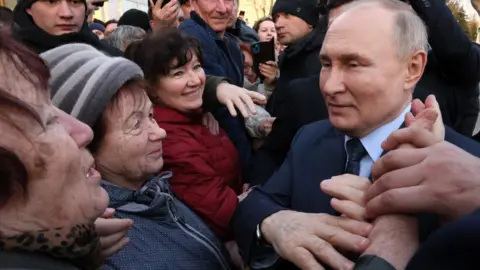 Getty Images Vladimir Putin greets crowds in Stavropol