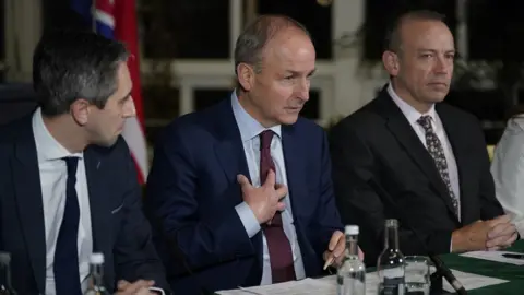 Niall Carson/PA Media Irish minister Simon Harris, Tánaiste Micheal Martin and Northern Ireland Secretary Chris Heaton-Harris