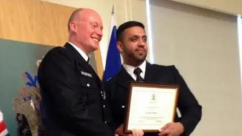 Metropolitan Police Kashif Mahmood receiving a police commendation