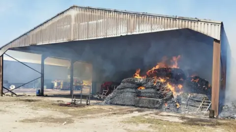 Cambs Fire and Rescue Straw on fire in a barn