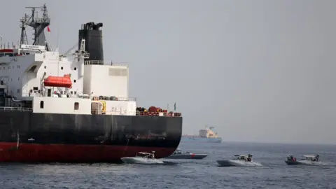 Reuters UAE Navy boats are seen next to Al Marzoqah, a Saudi Arabian tanker