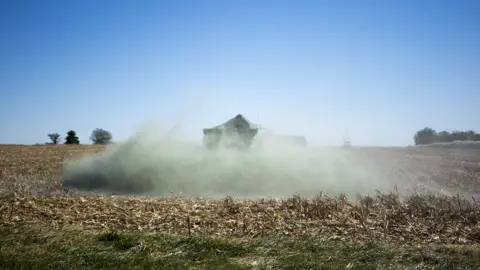 Uni ILLINOIS Volcanic rock being dumped on field