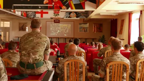 British soldiers watch the Queen's funeral