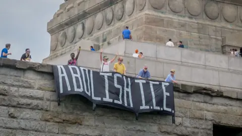 Getty Images Rise and Resist unfurl a banner