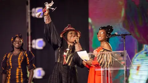 AFP Burkinabe director, Apolline Traoré (centre), wins the Etalon d'Argent for her film "Sira".
