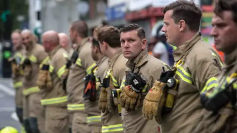 Getty Images Firefighters paying respects at the fourth anniversary memorial for the Grenfell fire