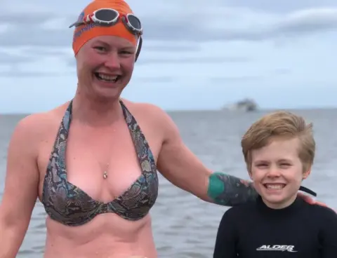 Gill Castle Gill and Sam in swimsuits in the sea