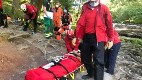 CBMRT rescuers with stretcher