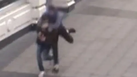 Norfolk Constabulary CCTV footage of Killick robbing a man (in purple top)