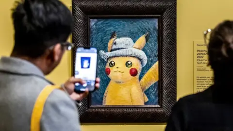 EPA Man taking photo of Pikachu painting in Van Gogh museum