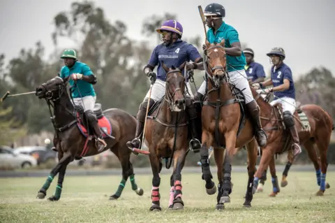 Luis Tato/AFP Polo players compete for the ball during the Casino Cup at the Nairobi Polo Club in Nairobi on September 24, 2023
