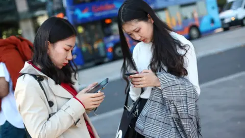 Reuters Mobile phone users