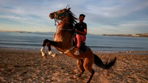 Reuters A rider reacts mounted on a horse on the beach in Tangier, Morocco - Sunday 26 March 2023