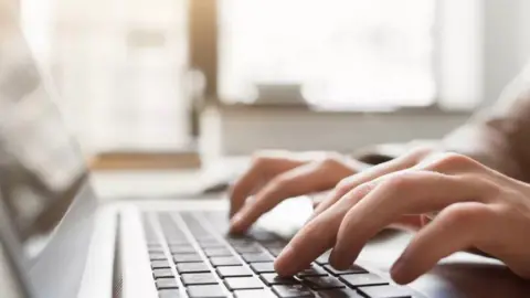 Getty Images A person typing on a laptop