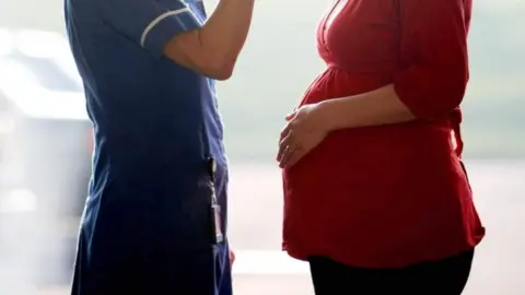 PA Media Midwife with patient