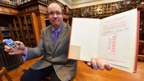 Middlesbrough Council Librarian David Harrington with the copy of Geoffrey Faber's The Buried Stream which was returned to Middlesbrough's Central Library after nearly 58 years