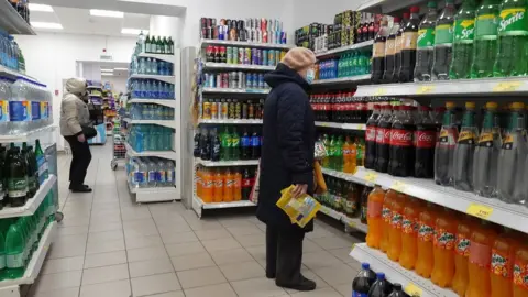 EPA People do shopping at the Russian retailer "Magnit" store, one of the country"s major supermarket chains, in Podolsk, outside Moscow, Russia, 21 April 2022