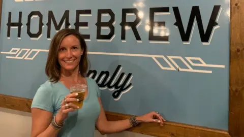 Renee Linnell Renee Linnell holds a beer