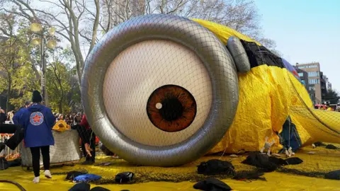 Minion balloon getting blown up