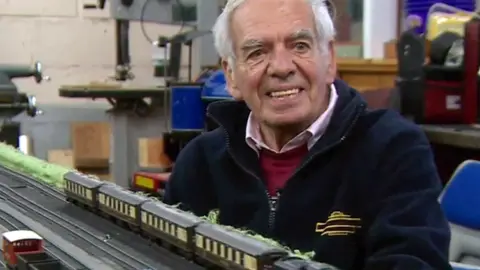 Vic Burgess in front of a model railway