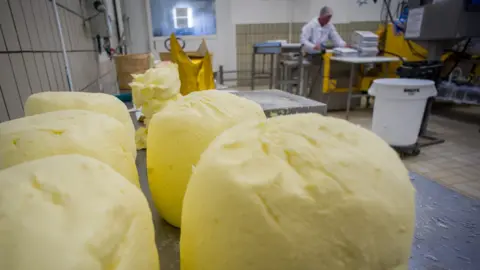 Large balls of butter on a worktop in a dairy