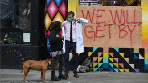 Getty Images A doctor in San Francisco speaks to homeless people about their health