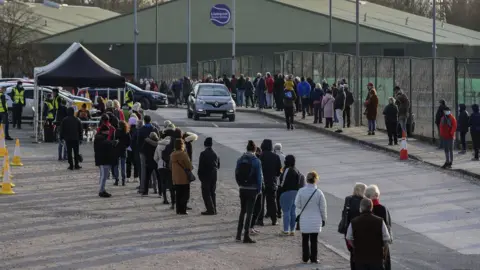 PA Media People waiting to be tested in Liverpool