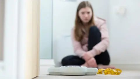 Getty Images teenage girl at scales