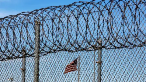 Reuters Barbed wire and an American flag at a prison in Louisiana