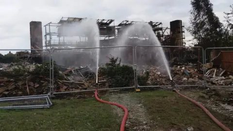 Cheshire Fire and Rescue Service Work continues at scene of fire