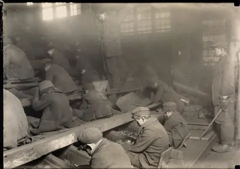 Courtesy of Swann Auction Galleries Small boys breaking coal.