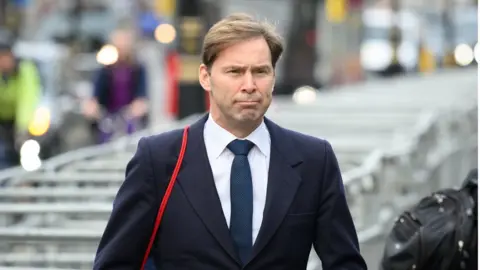 Getty Images Bournemouth East MP Tobias Ellwood walks through Westminster on February 02, 2022 in London, England.