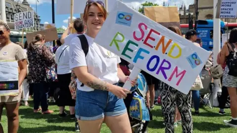 Lisa-Marie Reid Lisa-Marie Reid holds a placard calling for SEND reform