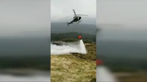 Helicopter putting out wildfire