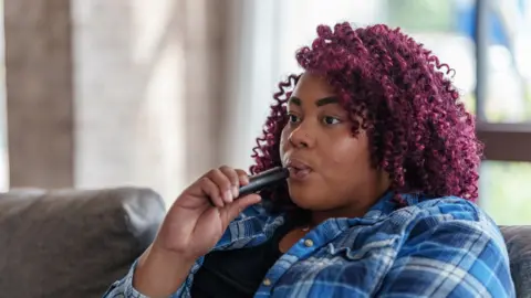 Getty Images Young woman vaping