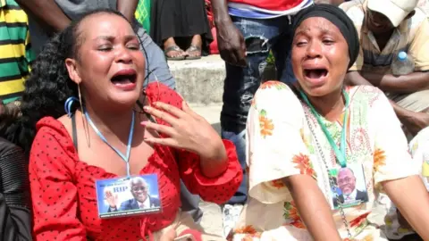 Reuters Mourners wept at the state funeral procession of Magufuli