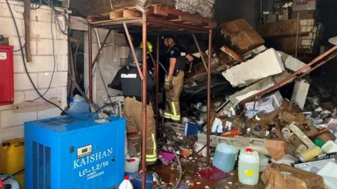 Reuters Israeli firefighters at site of rocket attack in Kiryat Shmona