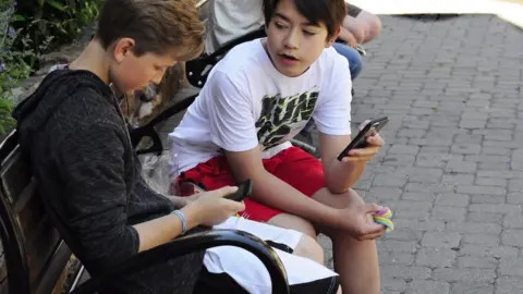Getty Images Children using a mobile phone