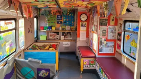 Ipswich Community Playbus The inside of the Ipswich Community Playbus, complete with sandpit, puzzles and paintings