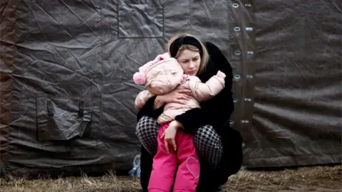 Reuters A mother and child at a refugee camp in Przemysl, Poland