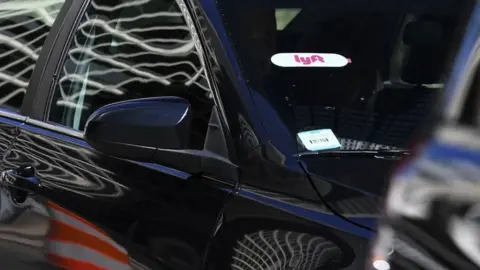 AFP The Lyft logo seen on a ride-hailing car