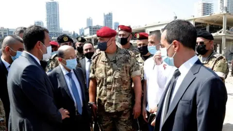 Reuters Lebanese President Michel Aoun (second left) visits Beirut's port on 5 August 2020