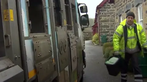 BBC A refuse collector in Conwy county