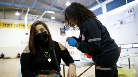 Reuters A woman in Tel-Aviv is vaccinated